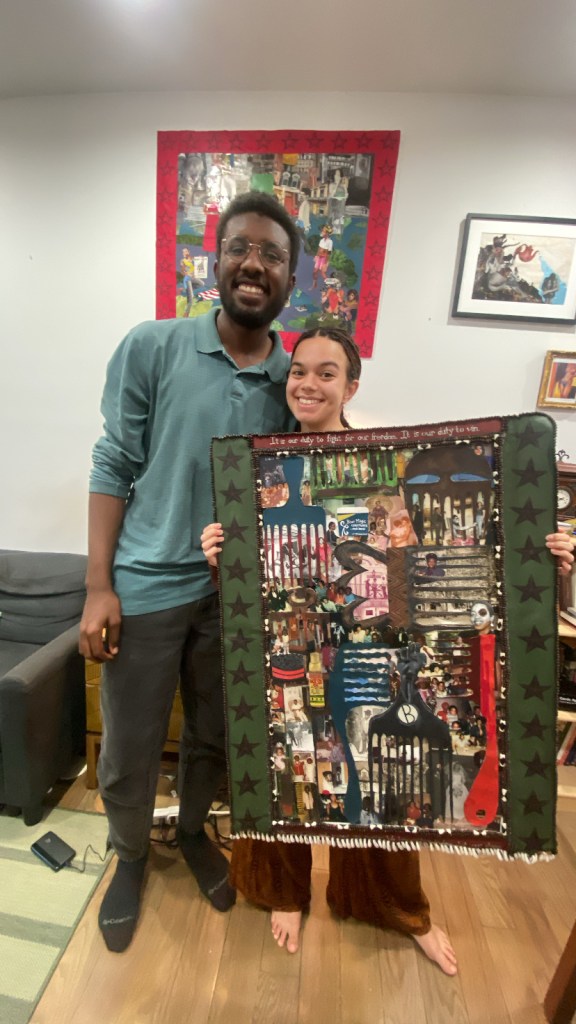 With Afro-Caribbean artist Marley Howard holding "Assata's Comb Through The Diaspora", an artwork commissioned by the Bandung Duo